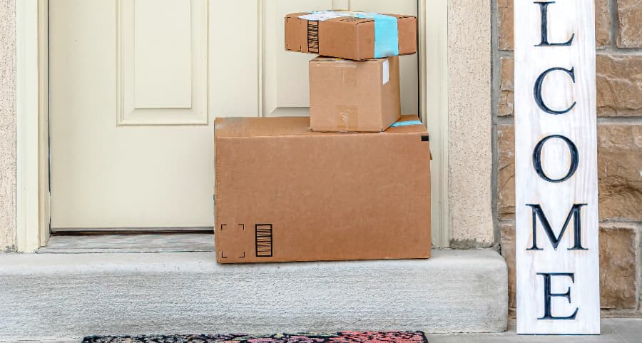 Packages on the doorstep of a home with a welcome sign in Baton Rouge